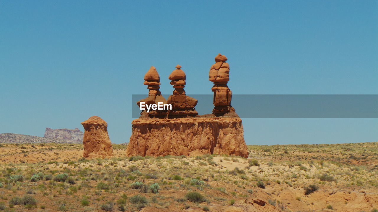Stack of rocks at goblin valley state park against clear blue sky
