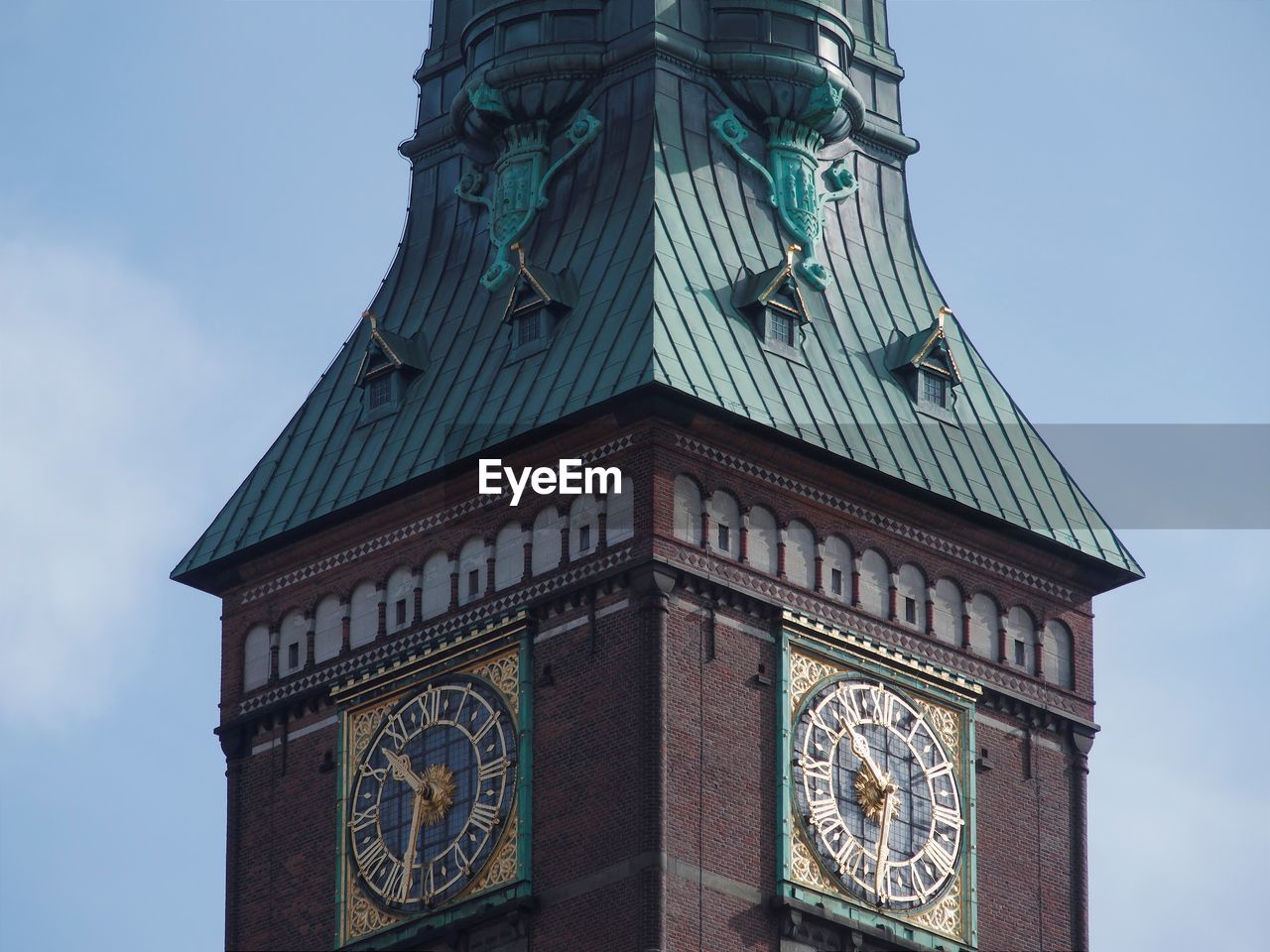 Low angle view of clock tower against sky