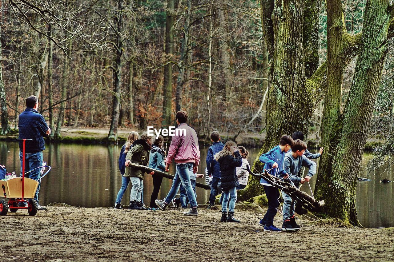 PEOPLE STANDING IN FRONT OF TREES