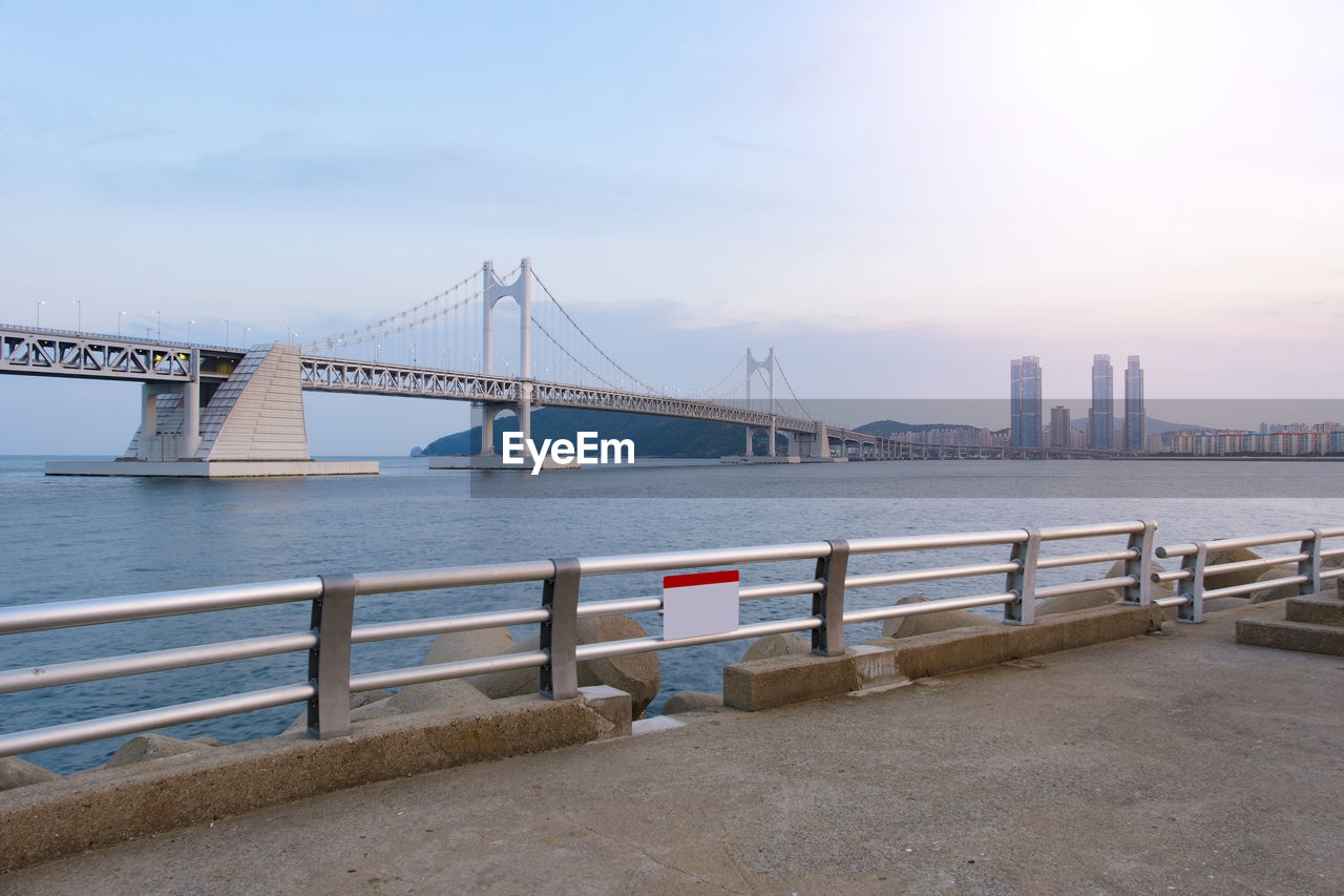 VIEW OF SUSPENSION BRIDGE OVER RIVER