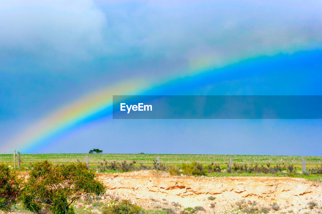 SCENIC VIEW OF RAINBOW OVER LANDSCAPE