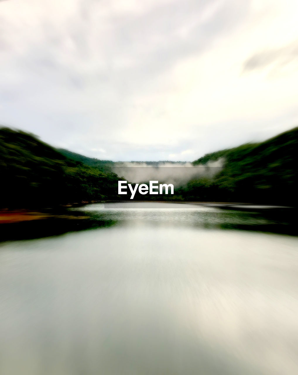 SCENIC VIEW OF WATER FLOWING THROUGH LAND AGAINST SKY