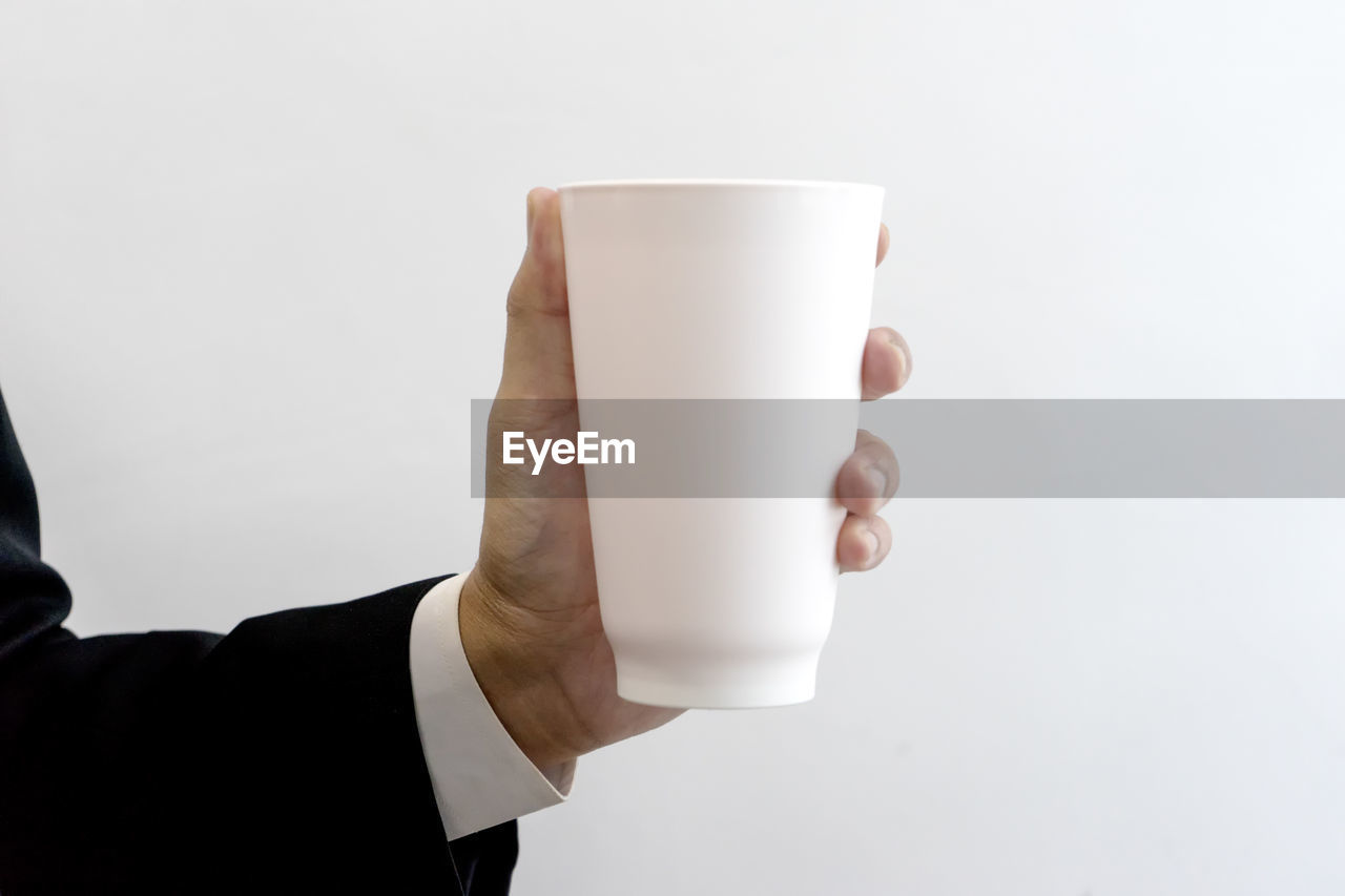 Businessman holding a white mug.