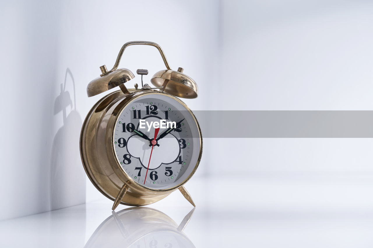 Vintage alarm clock on white background