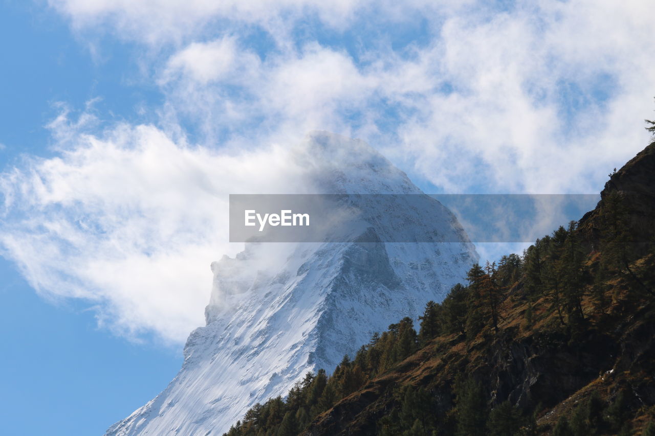mountain, sky, cloud, mountain range, nature, environment, scenics - nature, beauty in nature, landscape, land, ridge, travel, snow, mountain peak, no people, travel destinations, cold temperature, rock, outdoors, day, non-urban scene, winter, pinaceae, tree, tranquility, forest, tourism, blue, fog, pine tree, tranquil scene, coniferous tree, plant, summit, low angle view, idyllic, activity