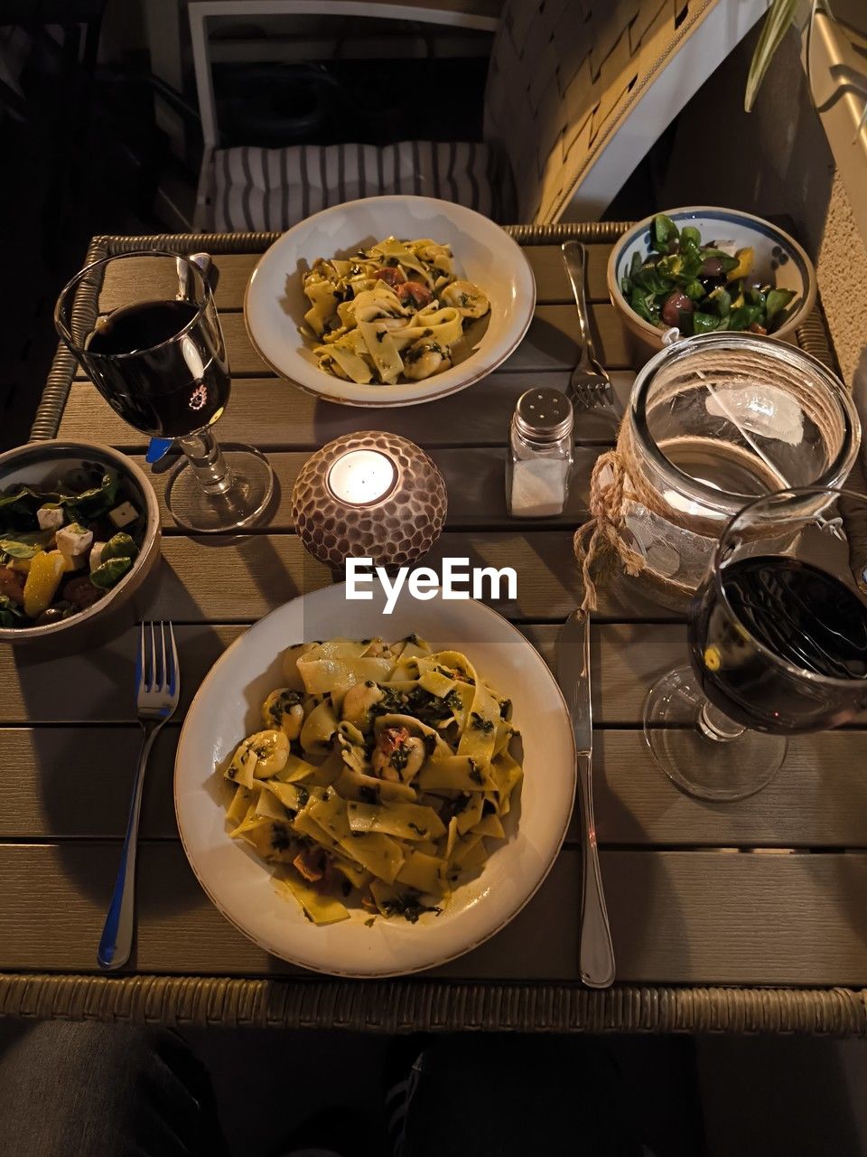 food and drink, food, high angle view, dinner, meal, table, healthy eating, indoors, freshness, plate, wellbeing, no people, italian food, kitchen utensil, bowl, pasta, still life, eating utensil, yellow, vegetable, household equipment, supper, directly above, restaurant, domestic room