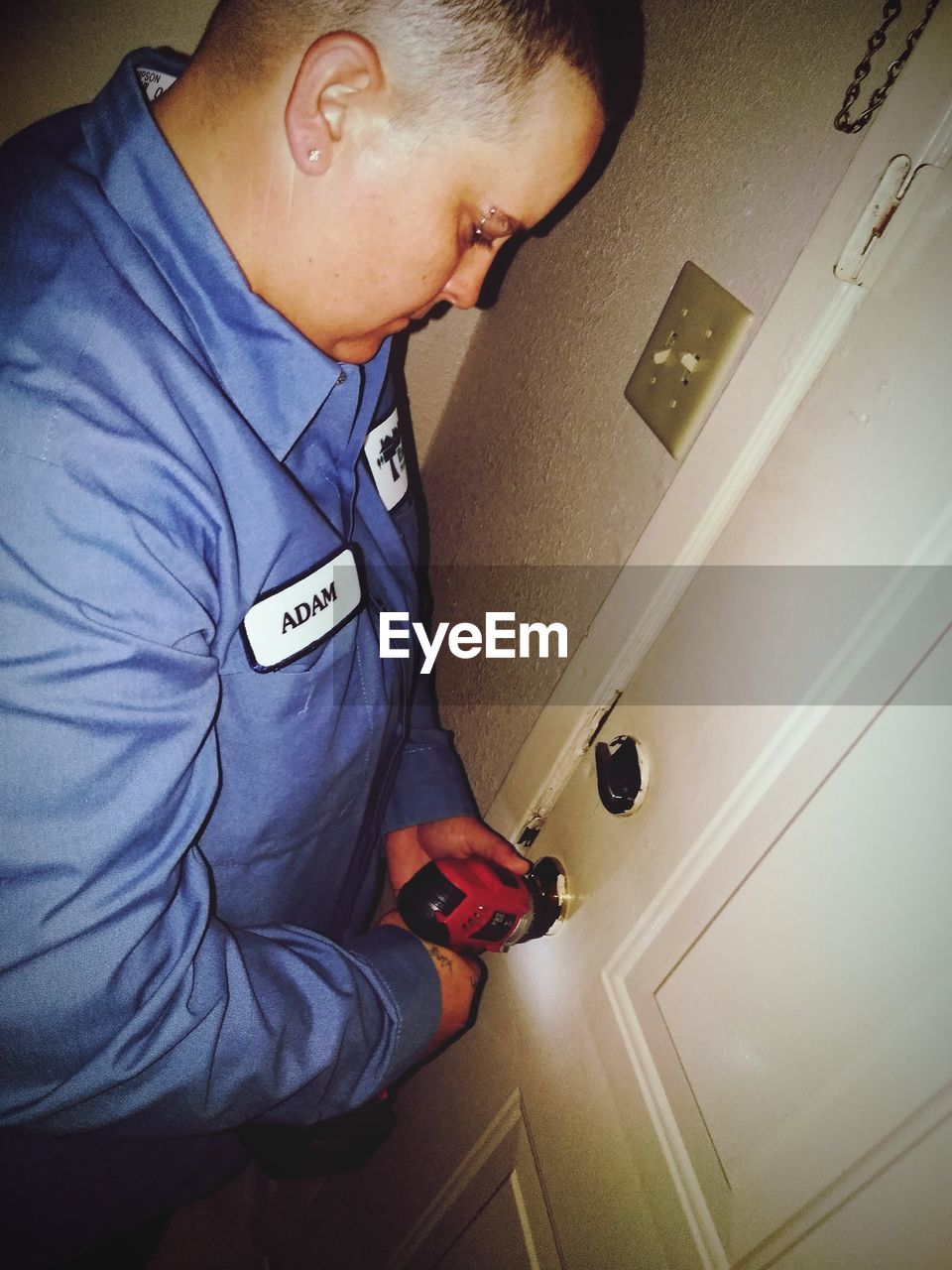 High angle view of man unlocking door