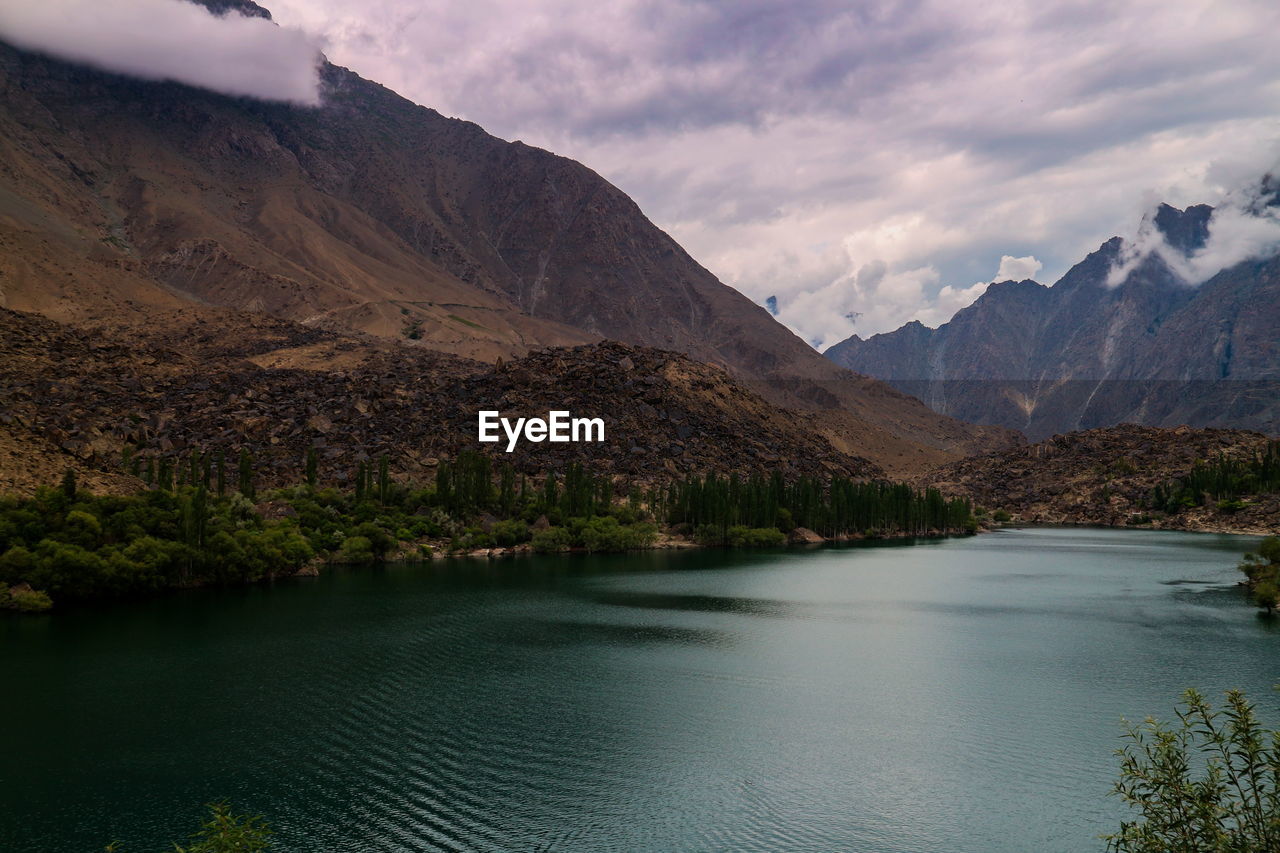 Scenic view of lake and mountains against sky