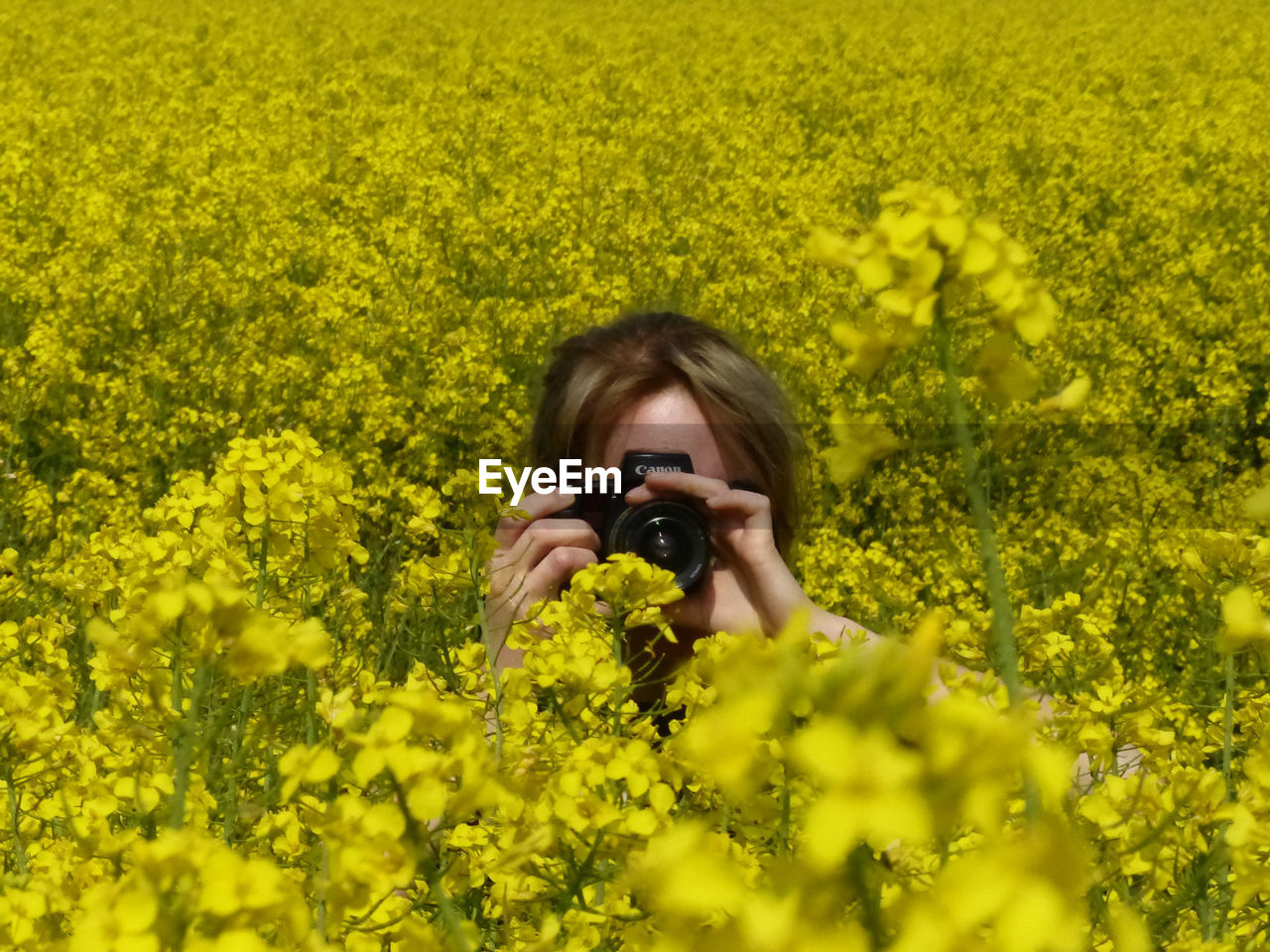 PORTRAIT OF YOUNG WOMAN WITH YELLOW CAMERA