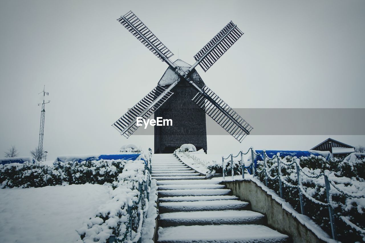 Low angle view of windmill during winter