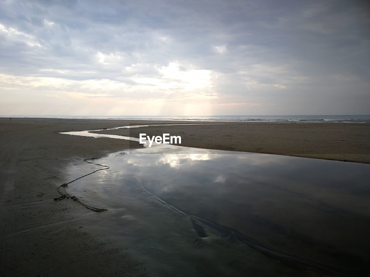 Scenic view of beach against sky during sunset