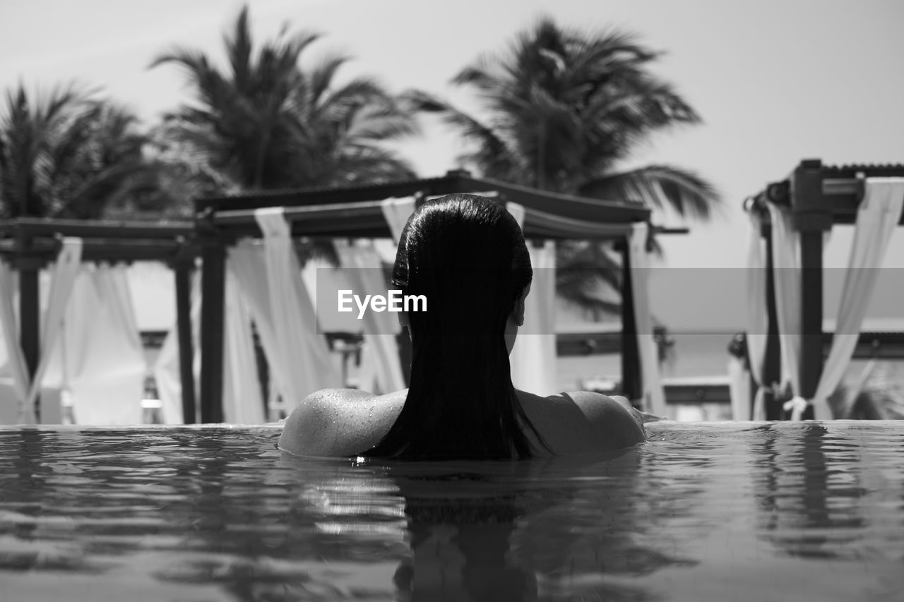 Rear view of woman in swimming pool