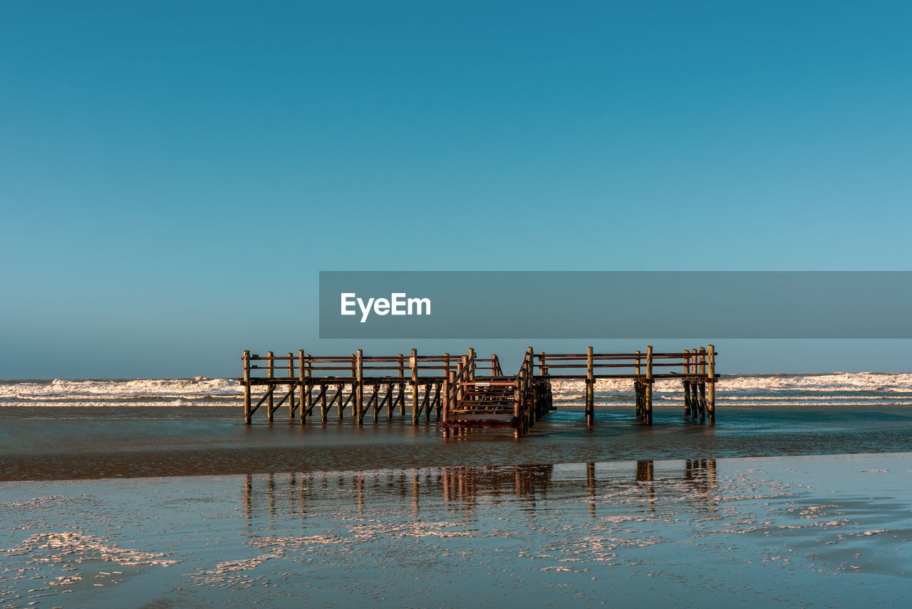 Pile dwelling on the norsee beach of sankt peter-ording in germany