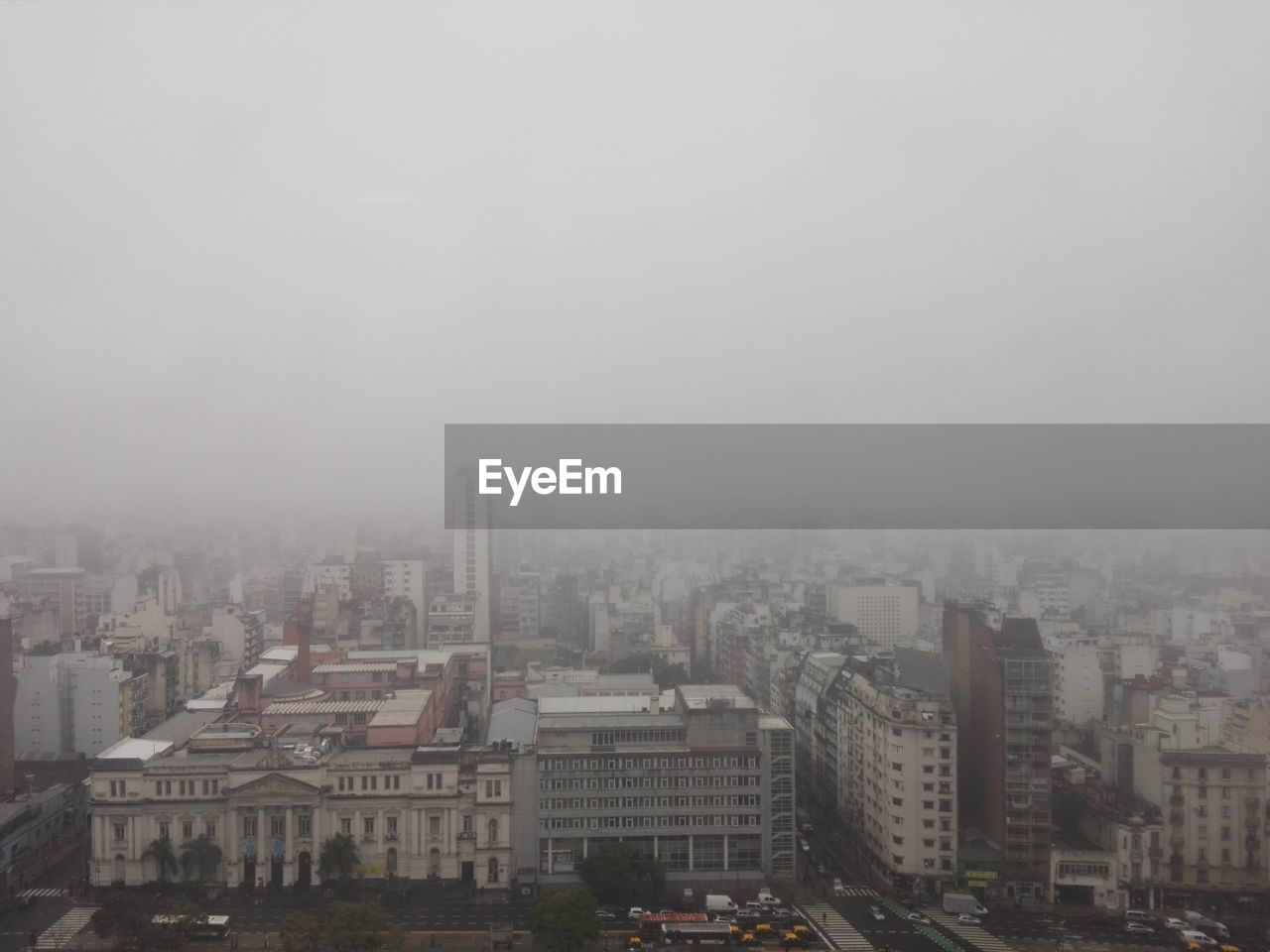 HIGH ANGLE VIEW OF BUILDINGS IN CITY AGAINST SKY DURING WINTER