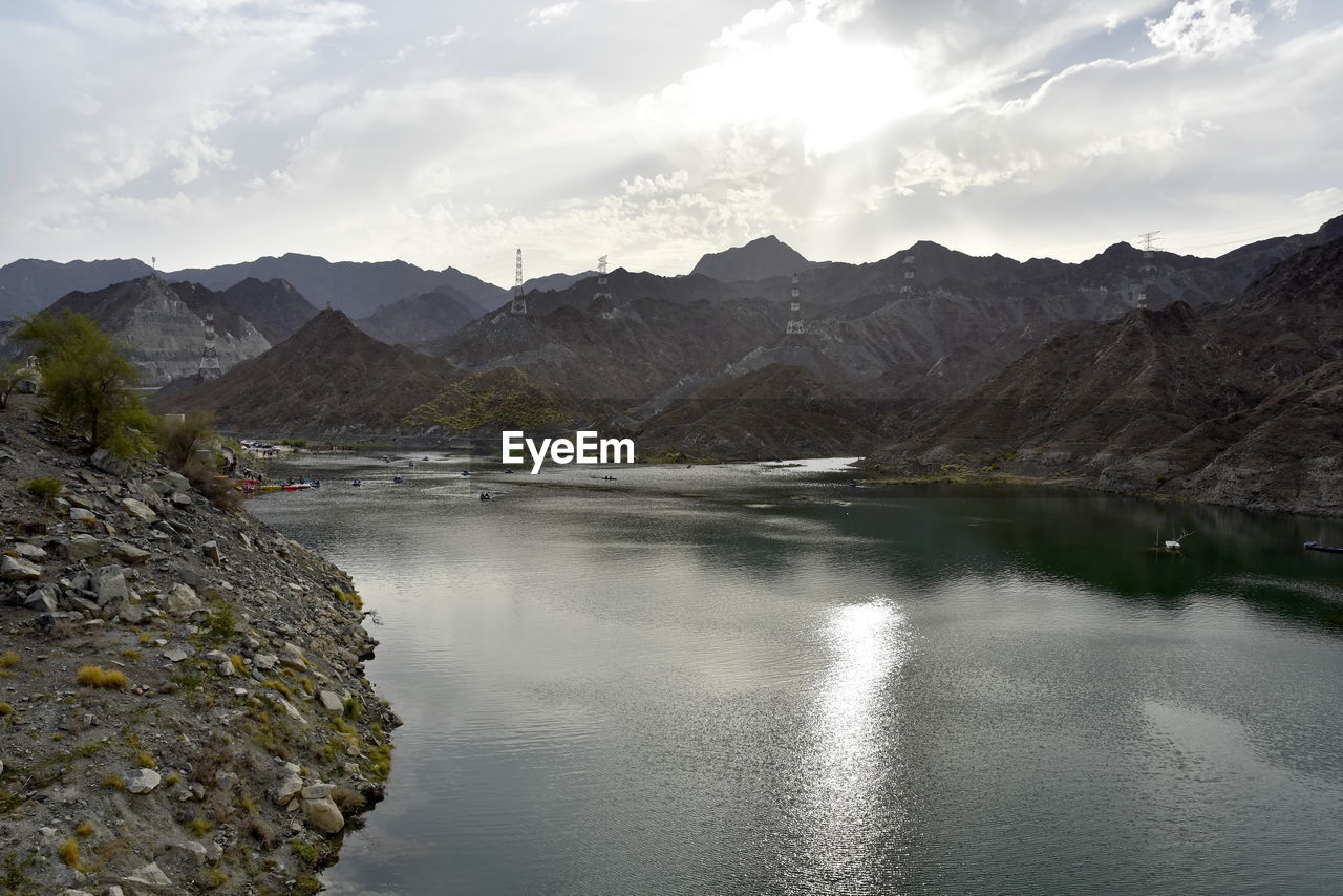 Scenic view of lake and mountains against sky