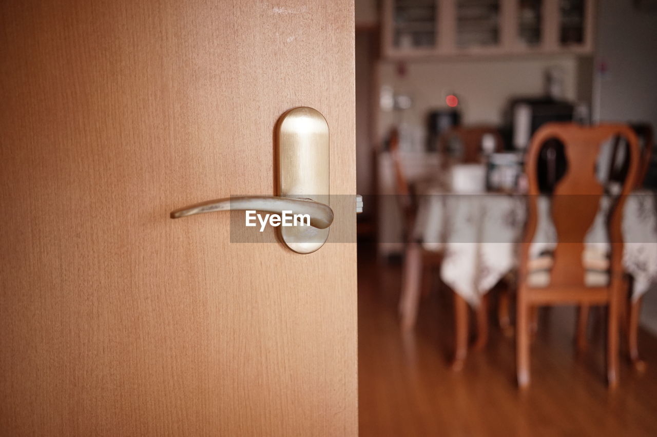 Close-up of door with dining room in background