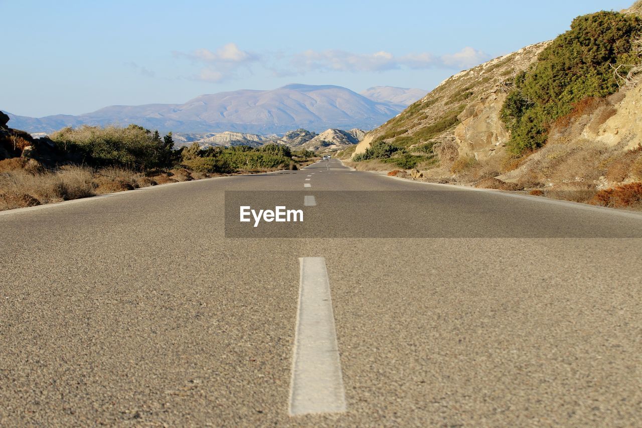 Road amidst mountains against sky