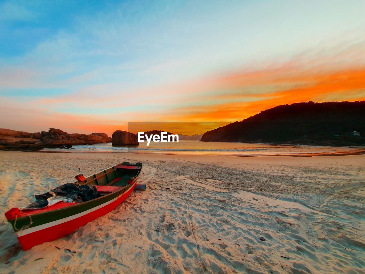 SCENIC VIEW OF BEACH DURING SUNSET