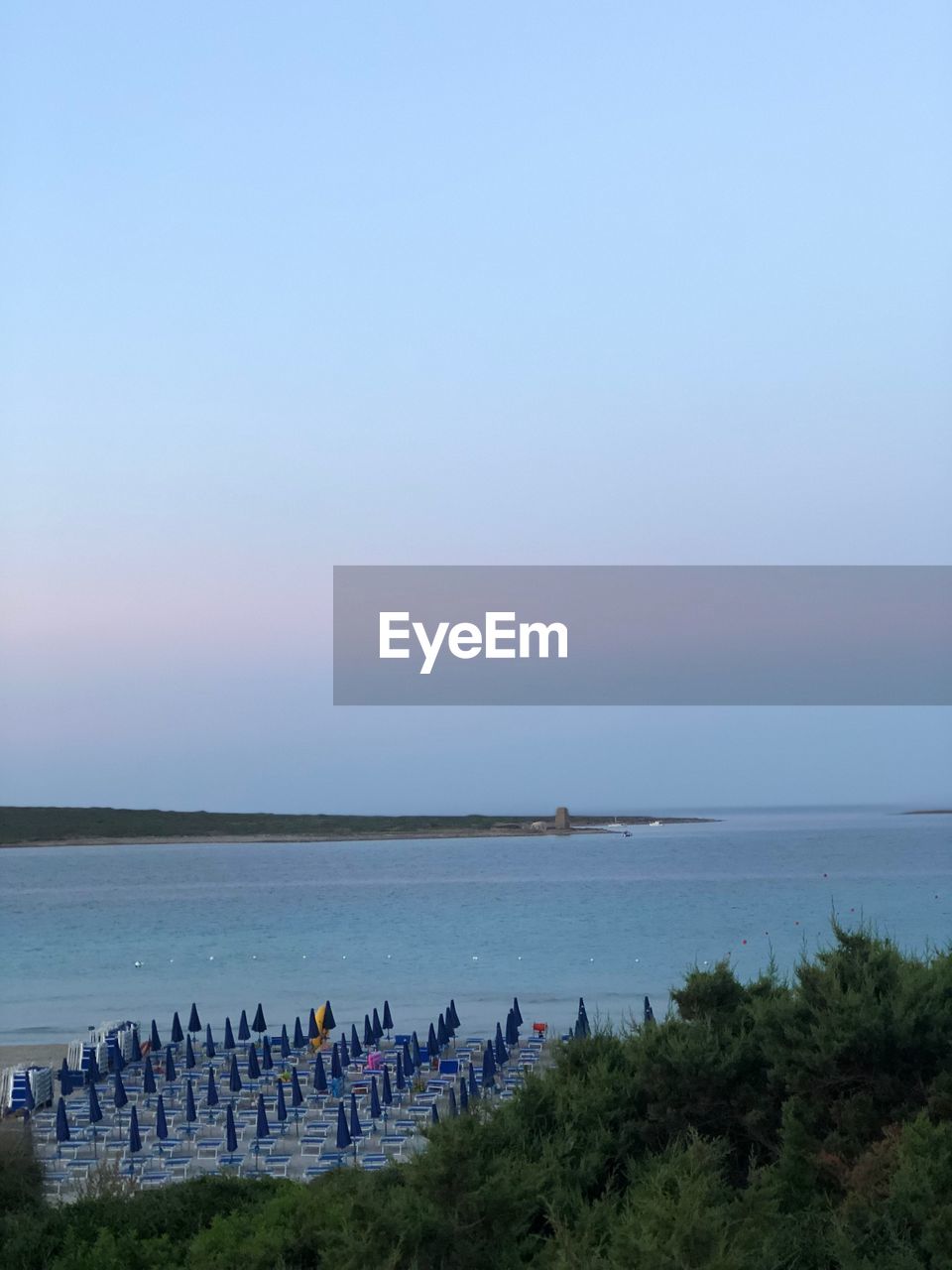 SCENIC VIEW OF BEACH AGAINST BLUE SKY