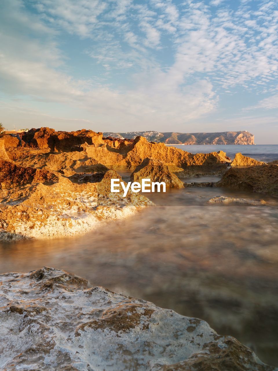 SCENIC VIEW OF ROCKS IN WATER AGAINST SKY