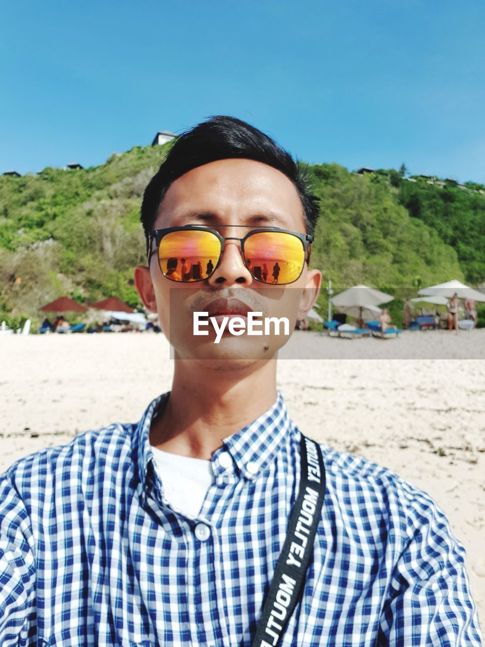 glasses, portrait, land, sunglasses, one person, beach, vacation, looking at camera, fashion, nature, front view, blue, leisure activity, day, sand, trip, sky, headshot, adult, men, holiday, young adult, summer, lifestyles, casual clothing, outdoors, sea, sunlight, smiling, child, travel, water, childhood, standing, goggles, sunny, checked pattern, waist up, striped, relaxation, travel destinations, clothing