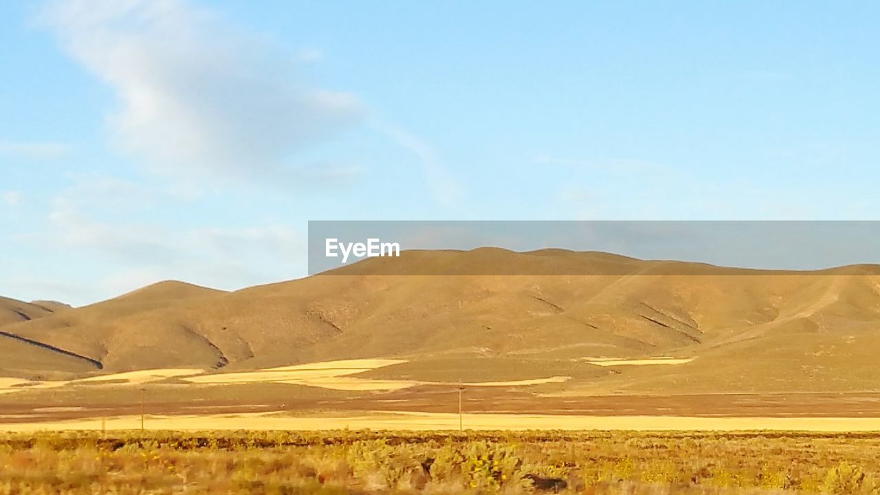 Scenic view of landscape and mountains against sky in desert