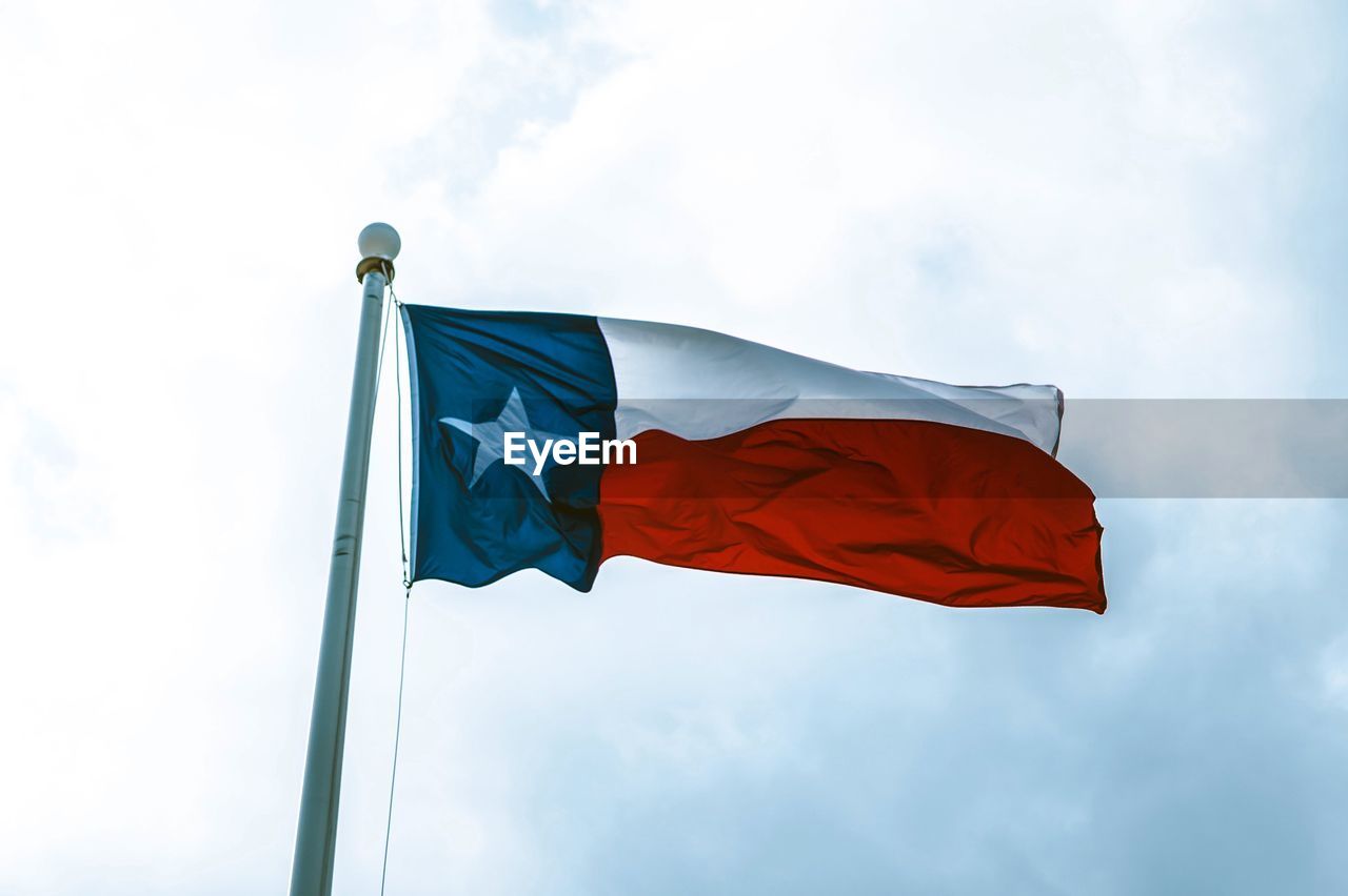 Low angle view of texas flag against sky