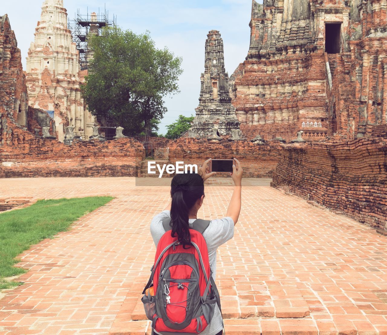 FULL LENGTH REAR VIEW OF MAN STANDING AT TEMPLE