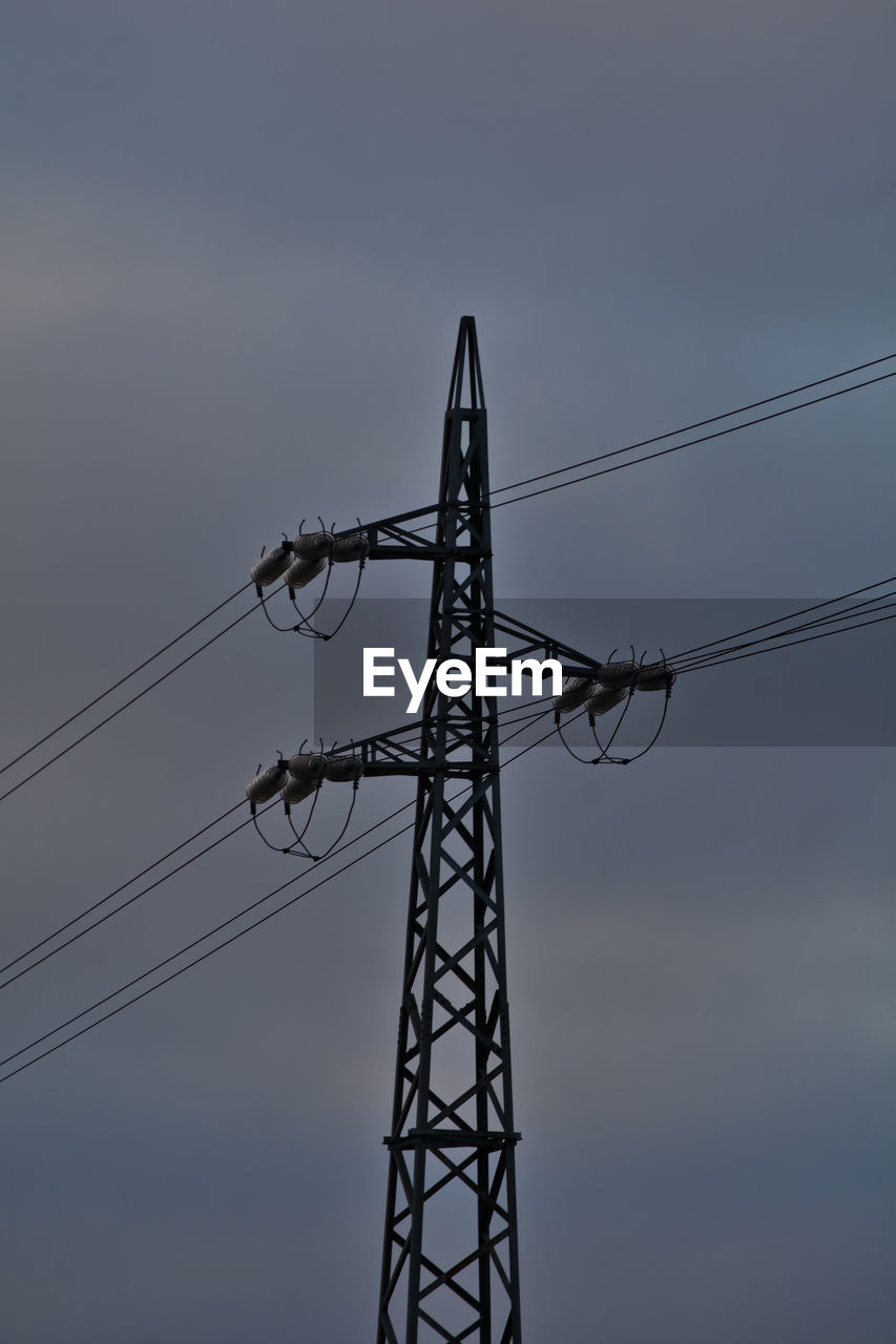 electricity, technology, cable, electricity pylon, power generation, power supply, sky, transmission tower, overhead power line, power line, tower, line, no people, outdoor structure, nature, silhouette, low angle view, electrical supply, mast, communication, cloud, outdoors, public utility, architecture, metal, built structure, industry