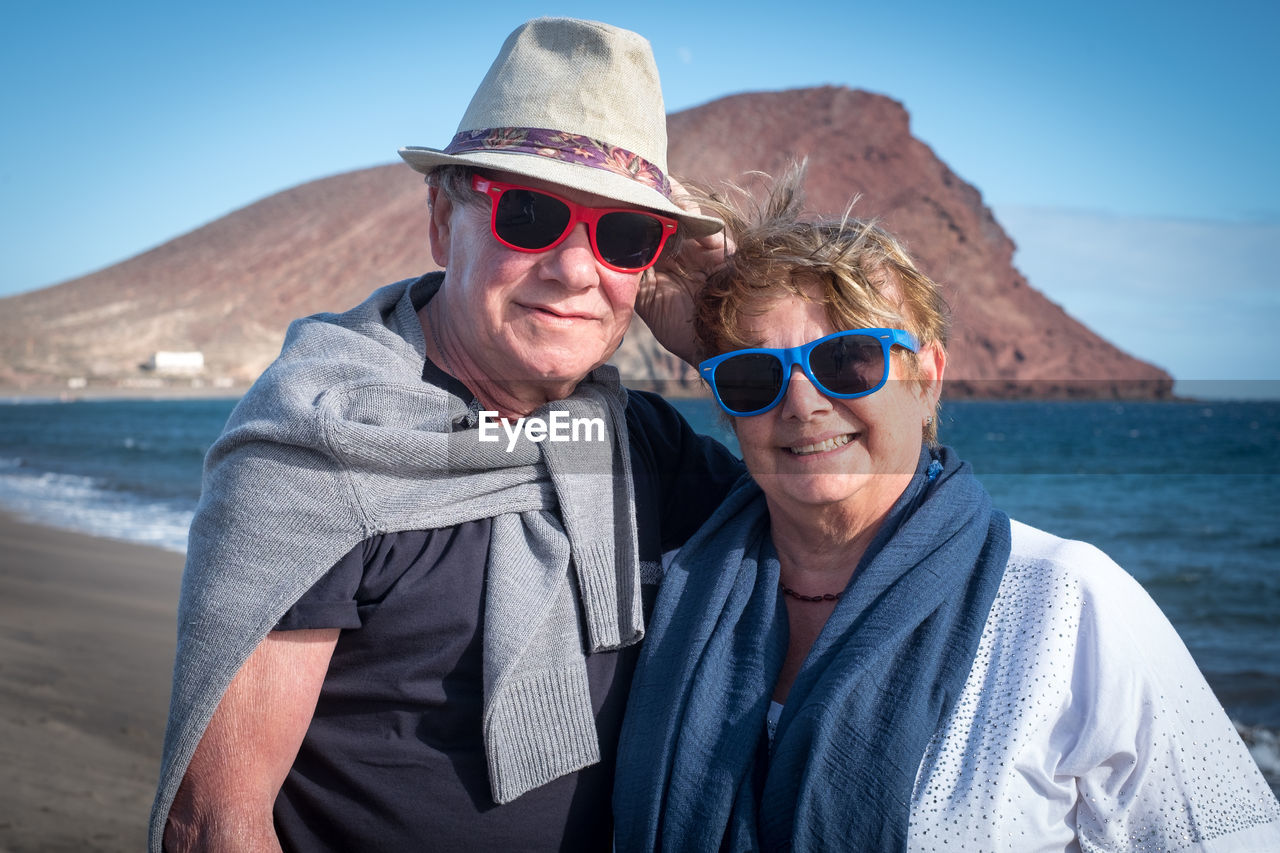Portrait of senior couple standing at beach