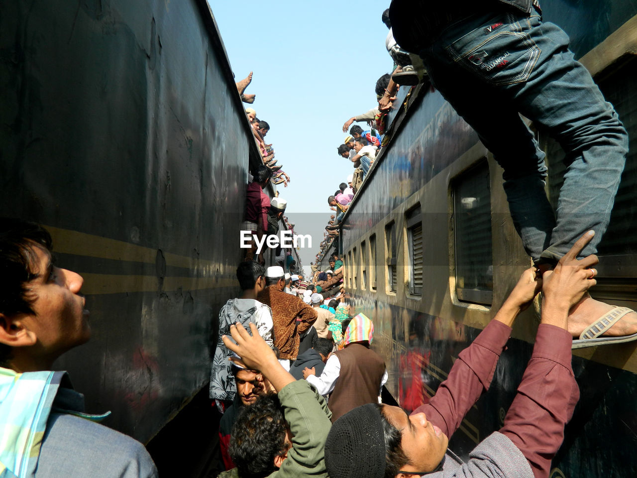 Crowd on train against sky