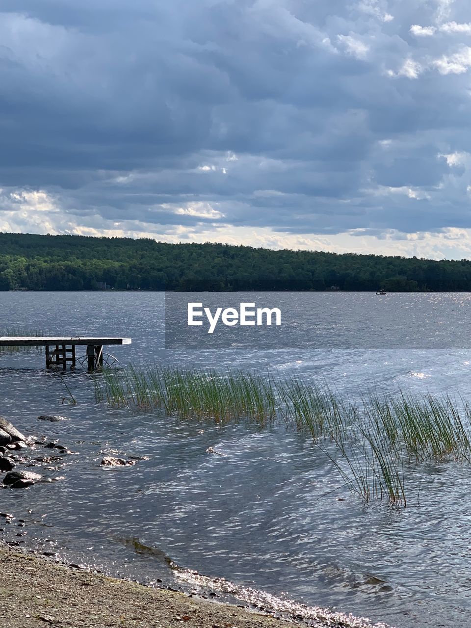 VIEW OF CALM LAKE AGAINST SKY