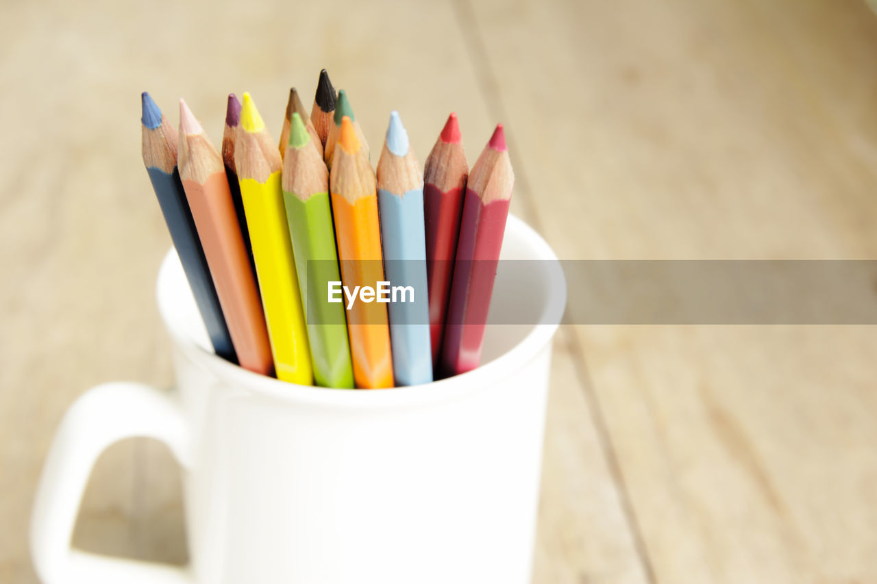 Close-up of colored pencils in mug