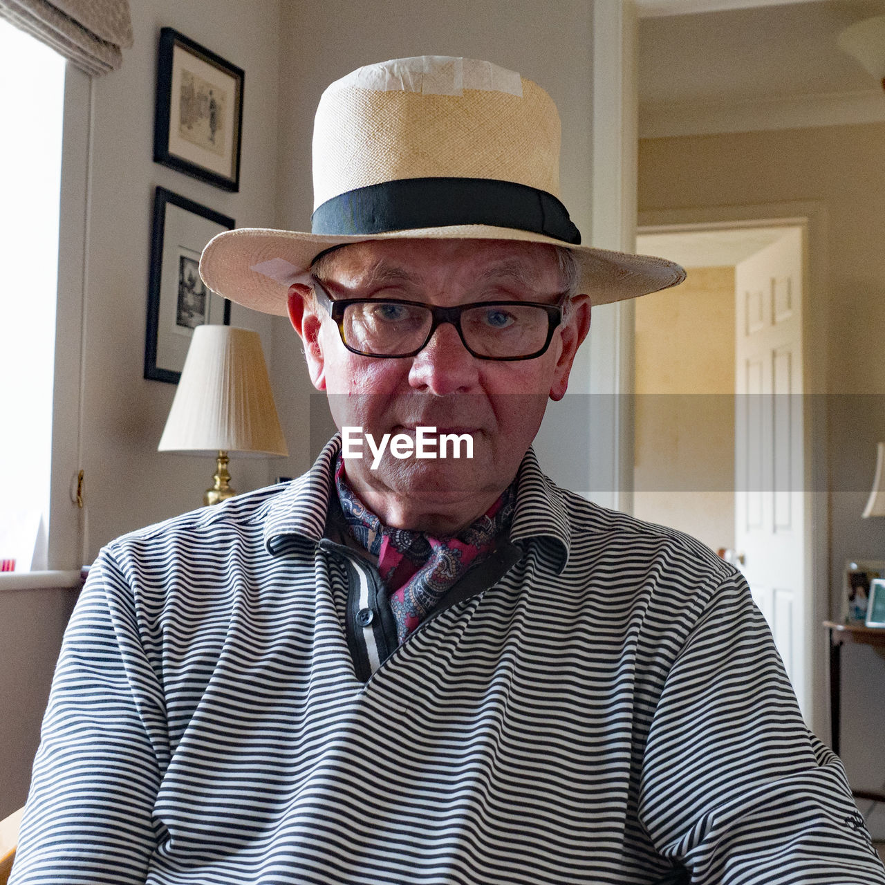 Portrait of senior man wearing hat at home