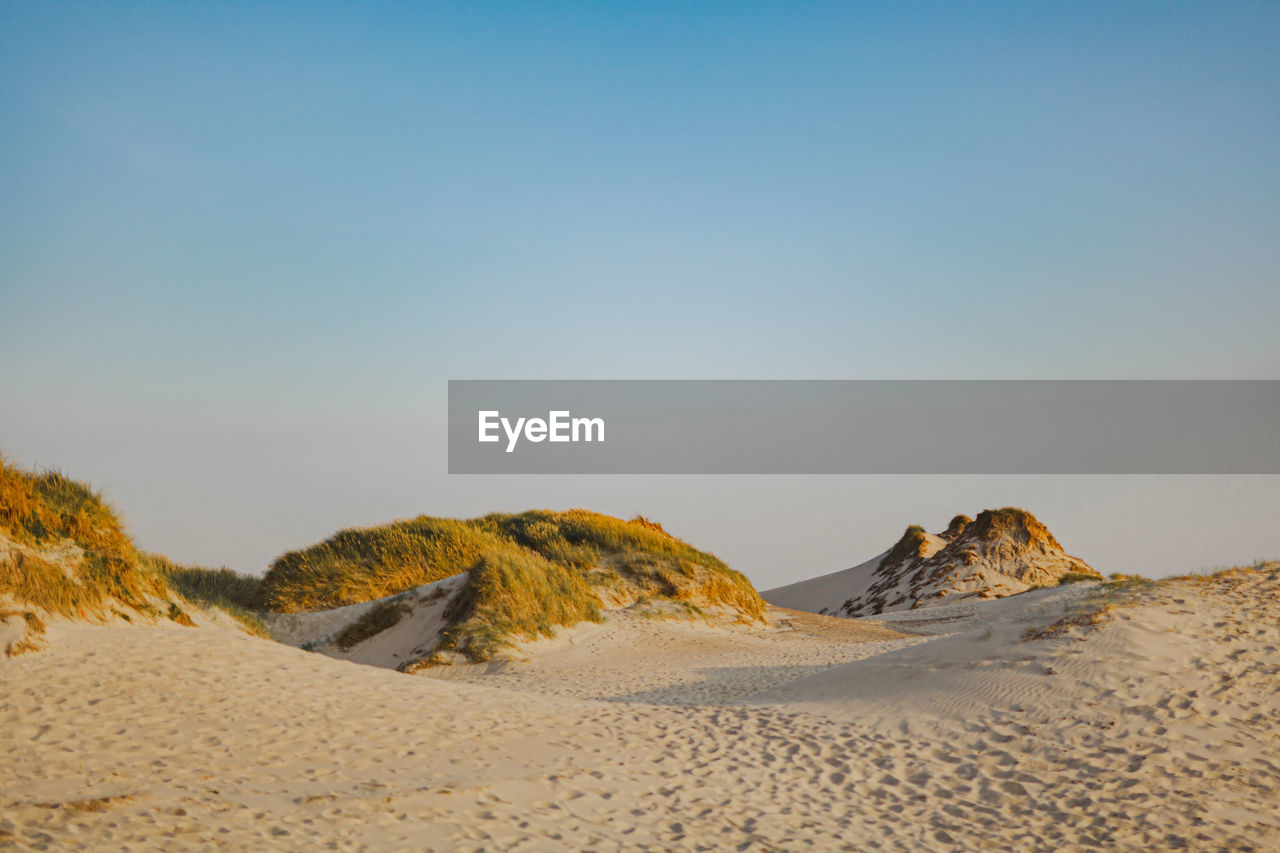 Scenic view of desert against clear sky