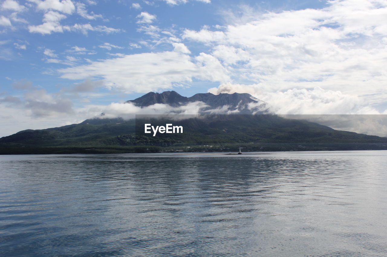 Scenic view of sea and mountains against sky