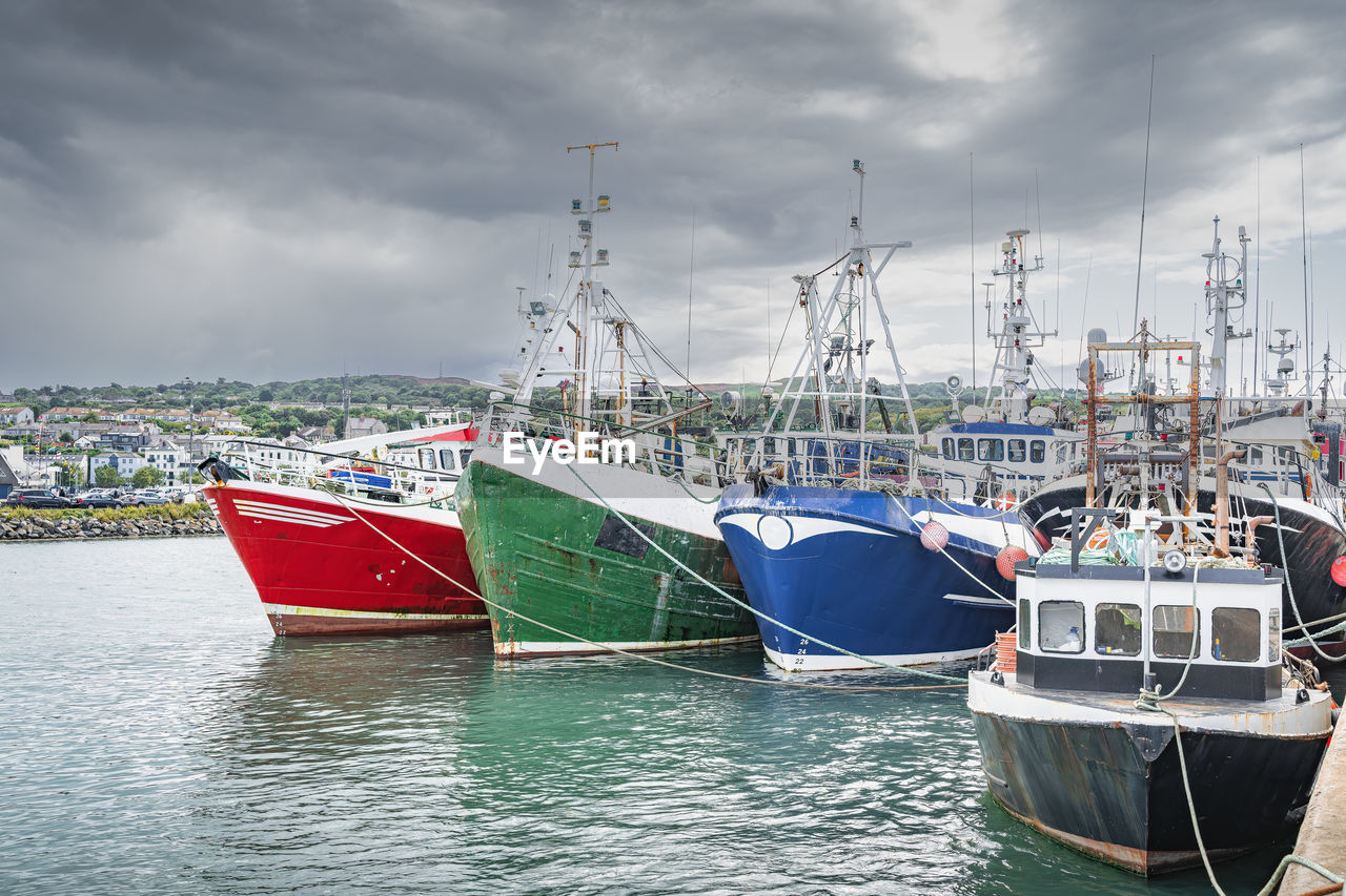 Several colourful fishing boats moored in howth harbour, dublin, ireland