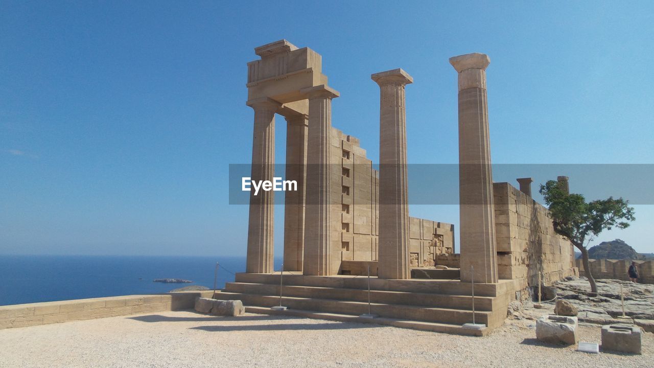 Temple of athena by sea against clear sky