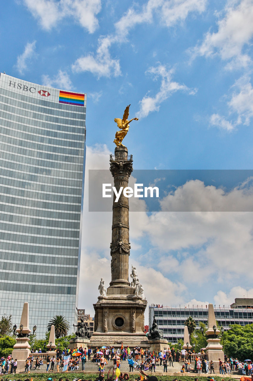 STATUE IN CITY AGAINST SKY