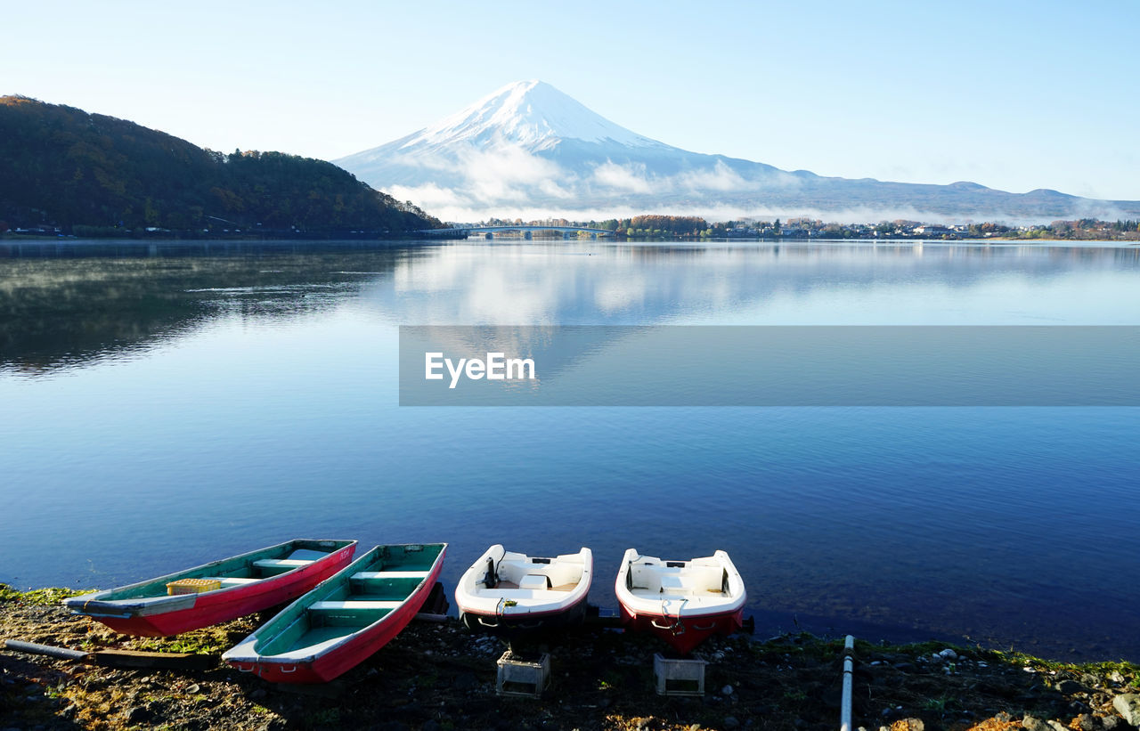 High angle view of lake and mountains against clear sky