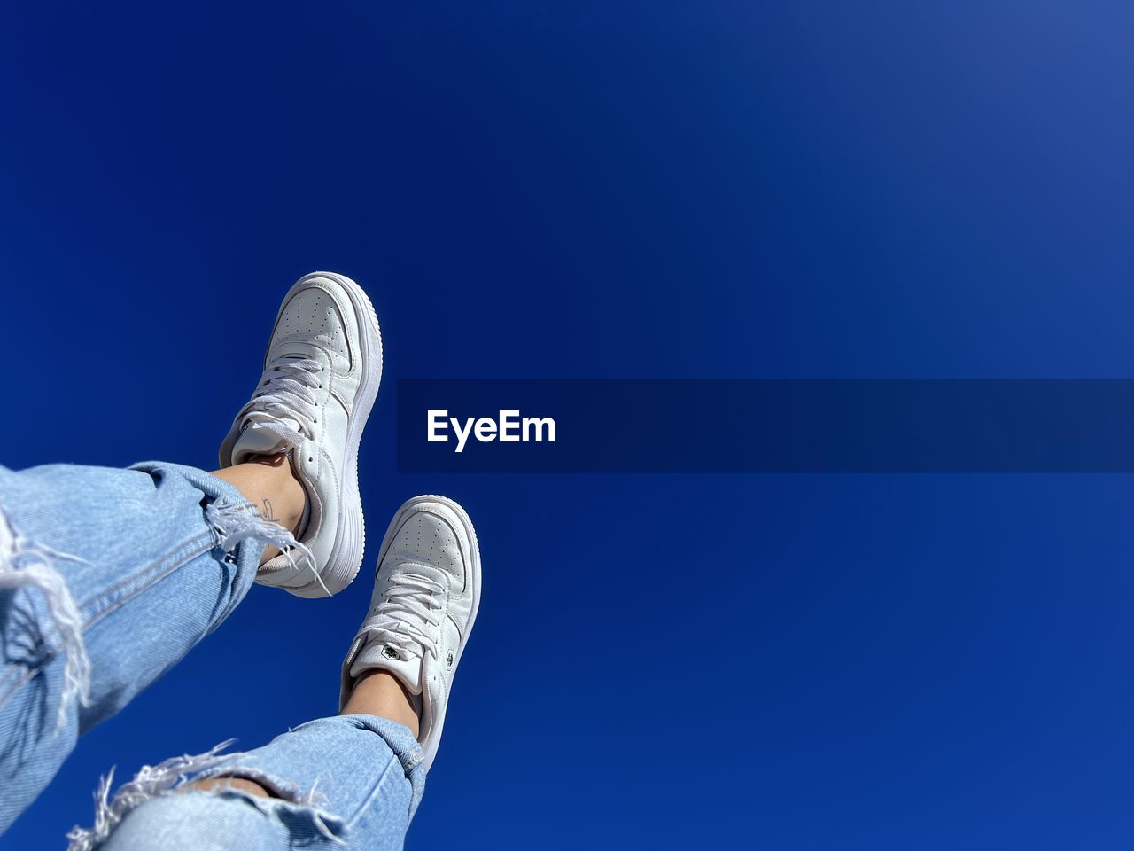 blue, shoe, one person, low section, human leg, copy space, personal perspective, limb, jeans, human limb, clear sky, sky, lifestyles, leisure activity, nature, day, low angle view, casual clothing, adult, footwear, men, outdoors, human foot