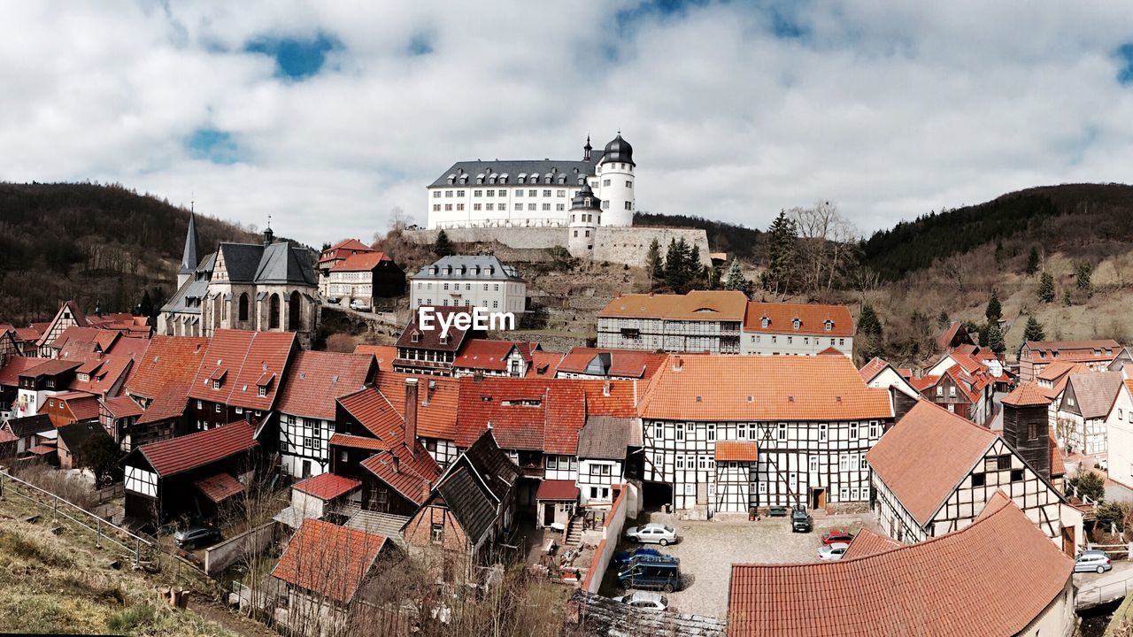 High angle view of town against cloudy sky