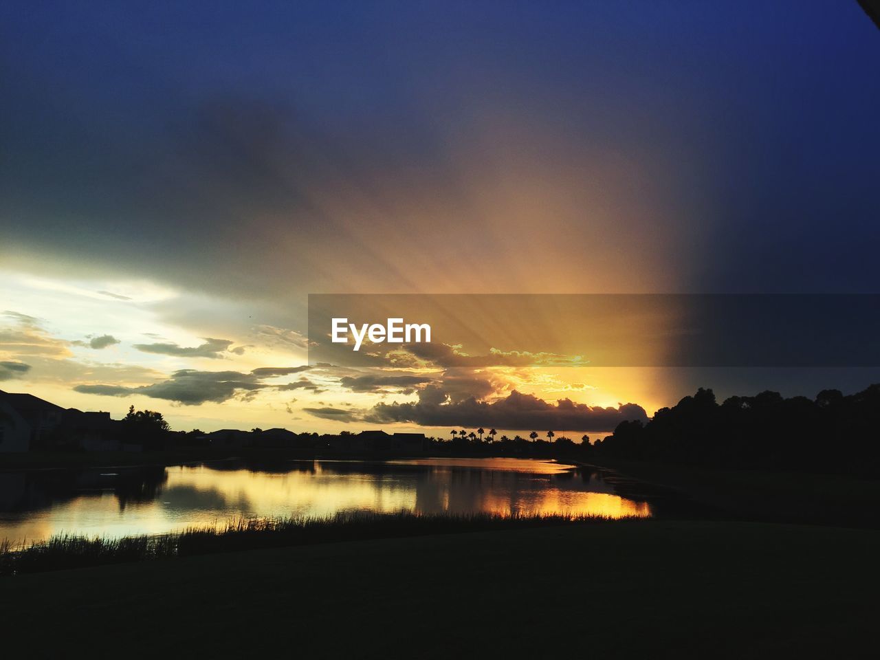 Scenic view of lake against sky during sunset