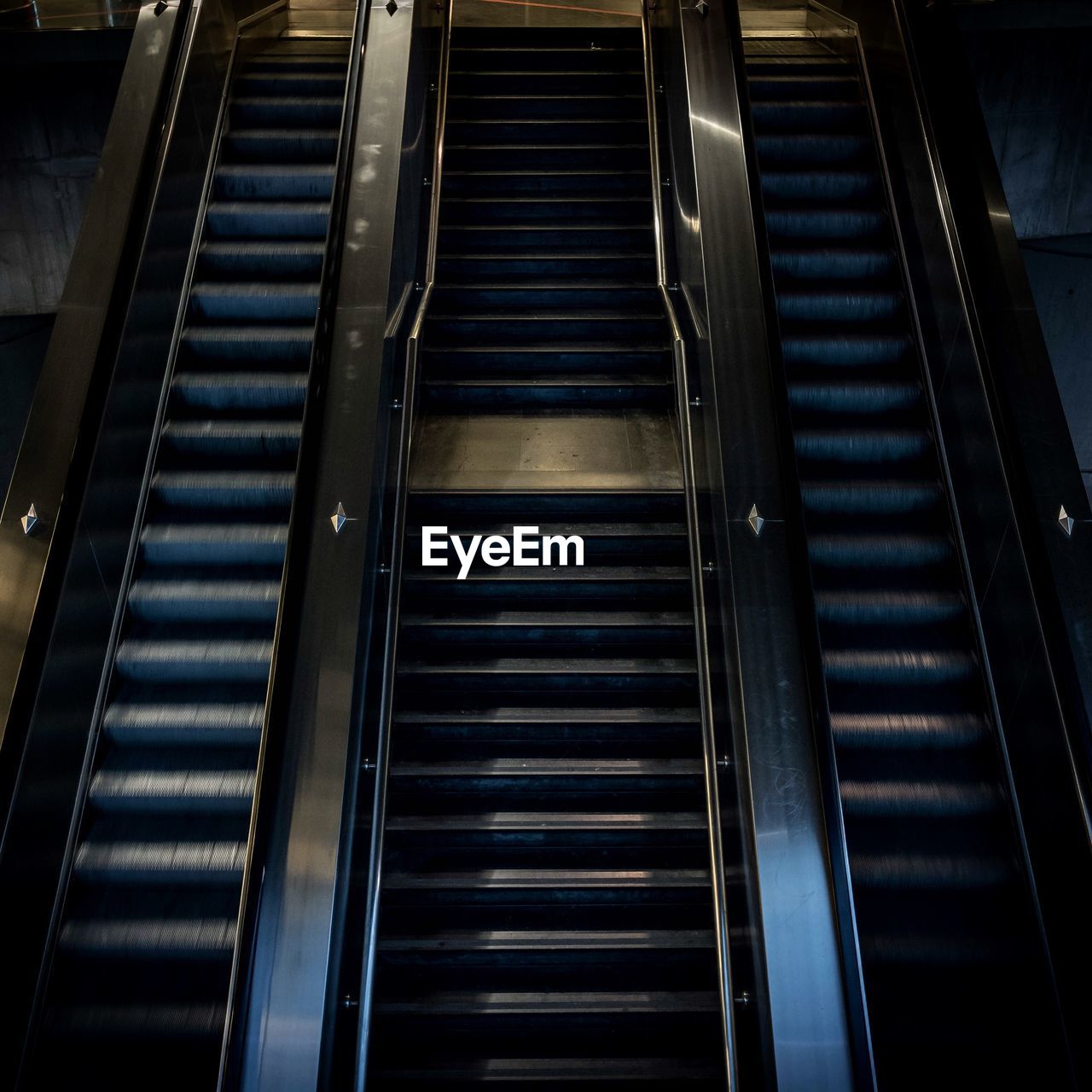 High angle view of staircase amidst escalators