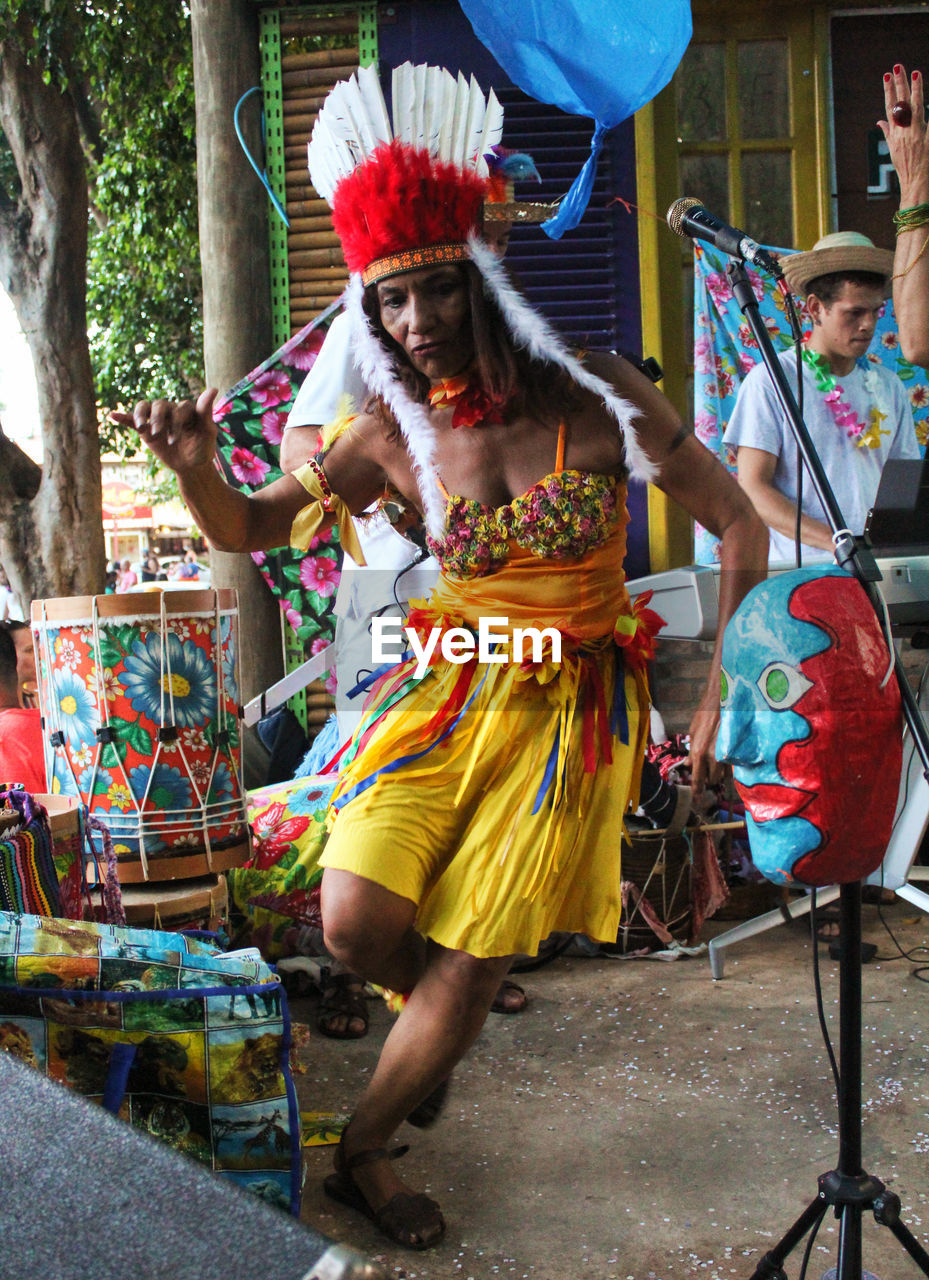 WOMAN WEARING MULTI COLORED UMBRELLAS