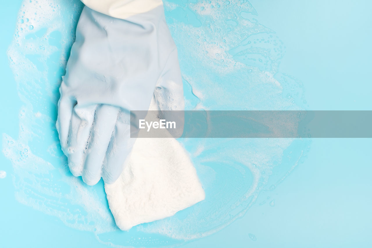 blue, turquoise, aqua, azure, hygiene, cleaning, petal, washing, studio shot, indoors, water, colored background, blue background, white, soap sud, close-up, one person, clean, protective glove, teal, adult, protection, nature, healthcare and medicine