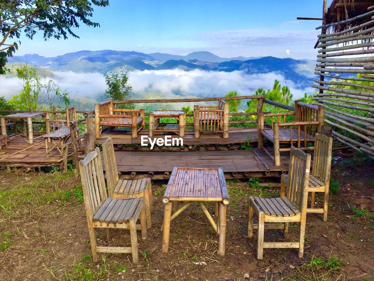 CHAIRS AND TABLE AGAINST MOUNTAIN RANGE