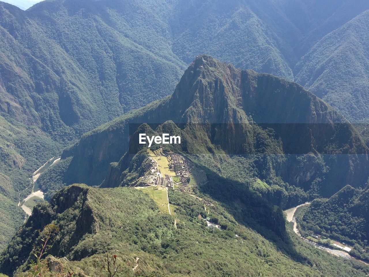 High angle view of machu picchu from machu picchu mountain surrounded by the urubamba river. 