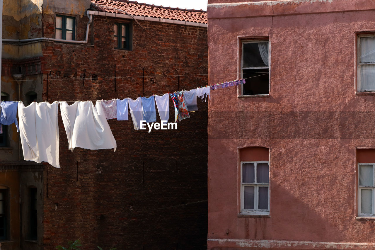 Low angle view of clothes drying outside building