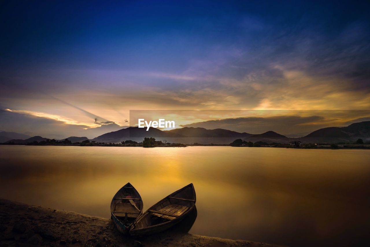 Scenic view of lake against sky during sunset